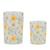 Two floral-patterned candles on a white background