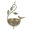Decorative metal bird bath with bird and leaf design on a white background