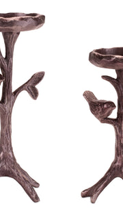 Two bronze-colored candle holders shaped like trees with birds on a white background
