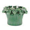 Green ceramic planter with floral designs on a white background