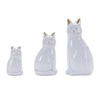 Three ceramic cat figurines of different sizes on a white background