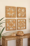 Four woven wall art pieces above a wicker console table with decorative items.