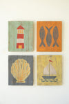 Four wooden wall art pieces with a lighthouse, fish, shell, and sailboat design on a white background.