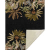 Rug with jungle-themed design featuring animals and plants on a black background