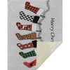Placemat with colorful Christmas stockings design and 'Merry Christmas' text on a gray background.
