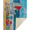 Rug with a beach scene design featuring a wooden chair, colorful presents, and a blue sky.