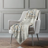 Floral-patterned blanket draped over a chair in a room with gray walls.