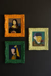 Set of three colorful framed acrylic portrait paintings