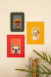 Set of three framed dog paintings on colorful backgrounds