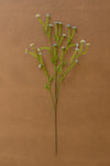 Artificial plant stem with small flowers on a brown background