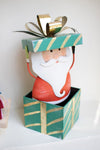 Painted metal Santa holding Christmas gift box