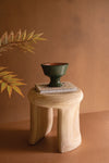 Carved wooden stool with round top