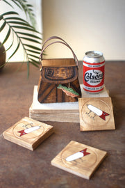 Wooden coasters with Colson's beer branding on a wooden surface.