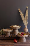 Wicker bowls on a wooden surface with a dark background