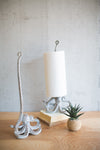 Decorative lamp with a white shade on a wooden surface next to a small plant.