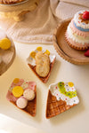 Assorted miniature desserts on a light surface with a neutral background