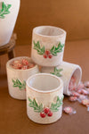 Hand-painted holly pattern clay container for holiday decor
