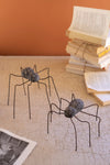 Whimsical spider sculptures with clay bodies and wire legs
