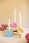 Heart-shaped conversation pieces with candles on a neutral background