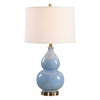 Table lamp with a blue ceramic base and white shade on a white background