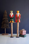 Decorative nutcrackers on wooden stands with a dark blue background