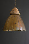 Vintage-style pendant light with wooden shade on a dark background