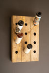 Wooden pegboard with bottles on a brown background