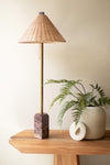 Table lamp with red marble base and rattan shade
