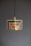 Decorative pendant light with geometric design on a gray background
