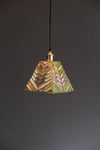 Decorative pendant light with geometric pattern on a dark background