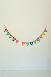 Colorful 'Happy Birthday' banner on a white wall
