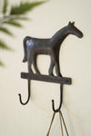 Decorative wall hook shaped like a horse on a light background