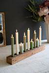 Wooden candle holder with lit candles on a dark background