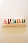 Decorative pillow with 'FA LA LA LA LA' text on a plain background
