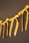 Yellow ribbon garland on a brown background