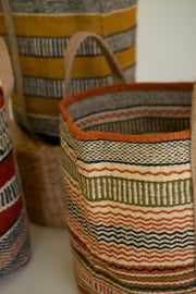 Woven baskets with striped patterns on a white surface