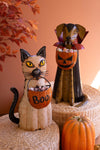 Halloween-themed cat and ghost decorations with 'Boo!' text on a textured surface.