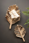 Decorative leaf-shaped trays made of natural materials on a dark background