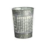 Metal flower pot with textured surface on a white background