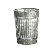Metal flower pot with textured surface on a white background
