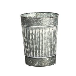 Metal flower pot with textured surface on a white background