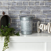 Decorative elements on a mantelpiece with a brick wall background