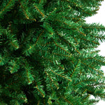 Close-up of a green artificial Christmas tree with detailed branches.