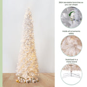 White Christmas tree with lights on a wooden floor against a white wall, featuring bendable branches and metal stand.