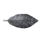 Decorative leaf-shaped object with detailed texture on a white background