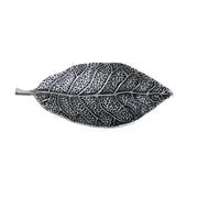 Decorative leaf-shaped object with detailed texture on a white background