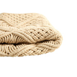 Beige knitted blanket on a white background