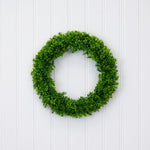 Green wreath on a white wooden background