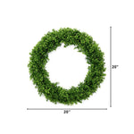 A green artificial boxwood wreath shown on a white background with dimension lines indicating a width and height of 20 inches.
