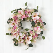Floral wreath with pink and white flowers on a white wooden background